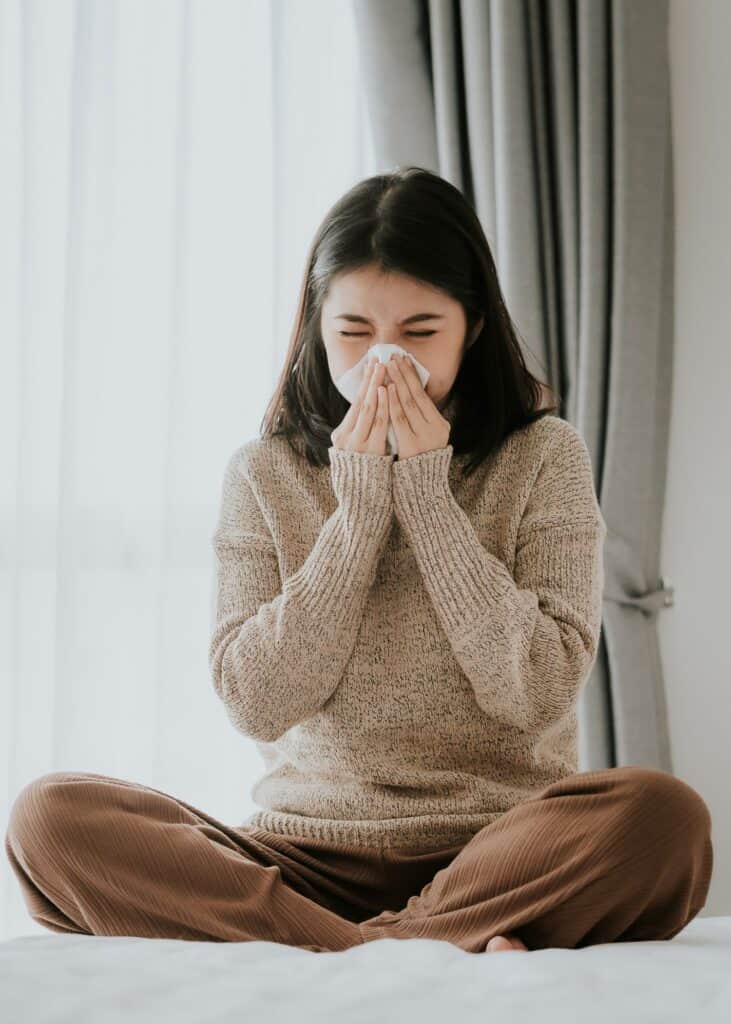 woman blowing her nose