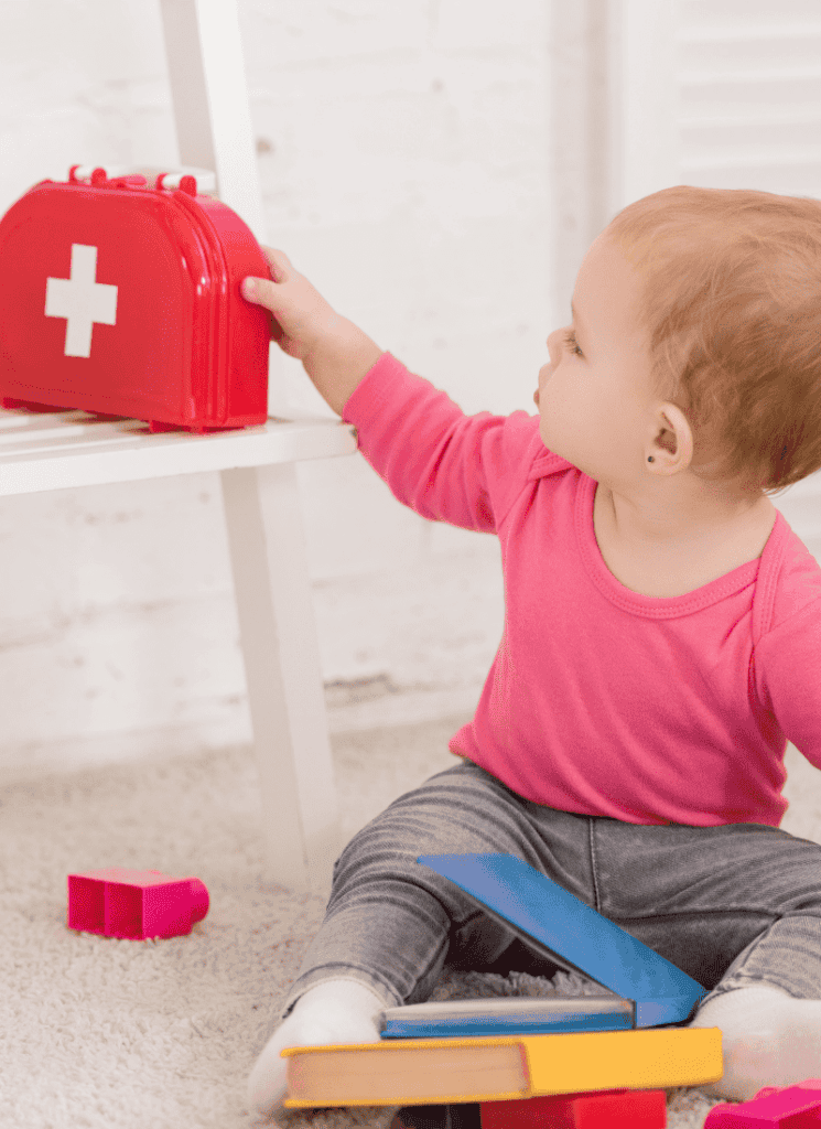 Baby with first aid kit