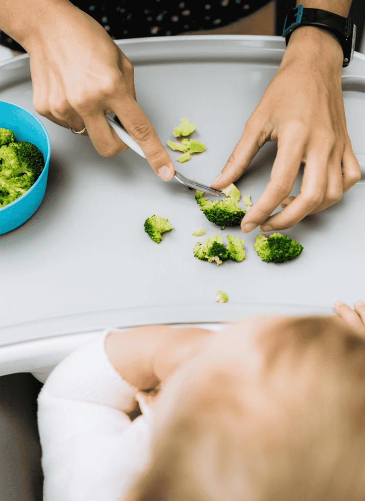 woman cutting broccoli