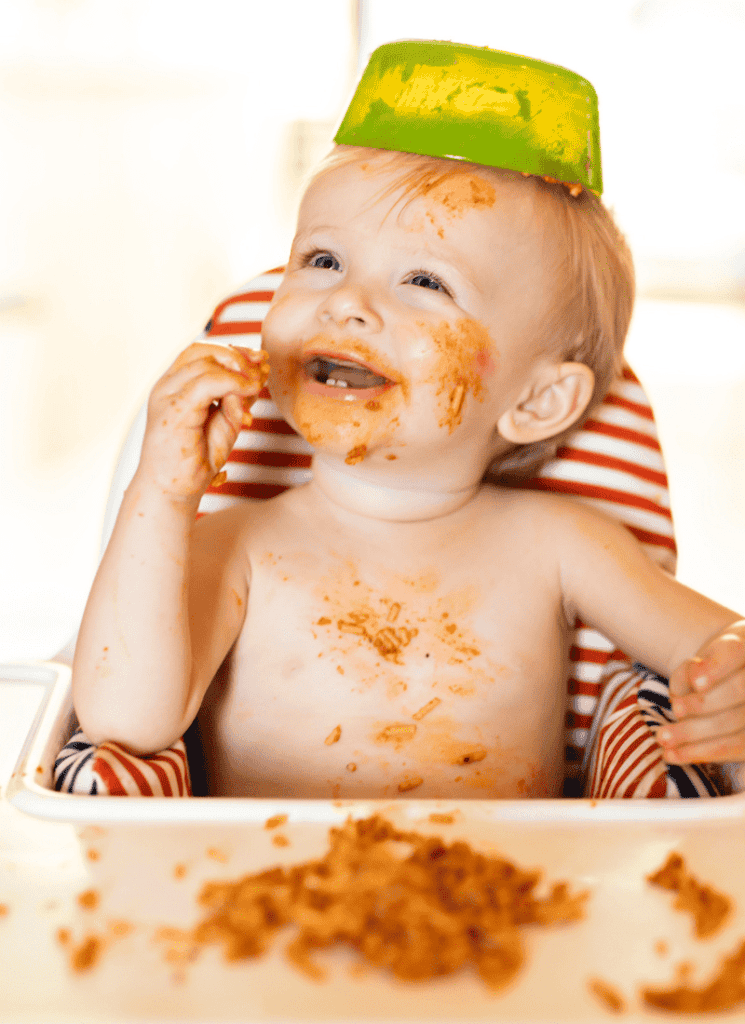 Baby with food all over their face